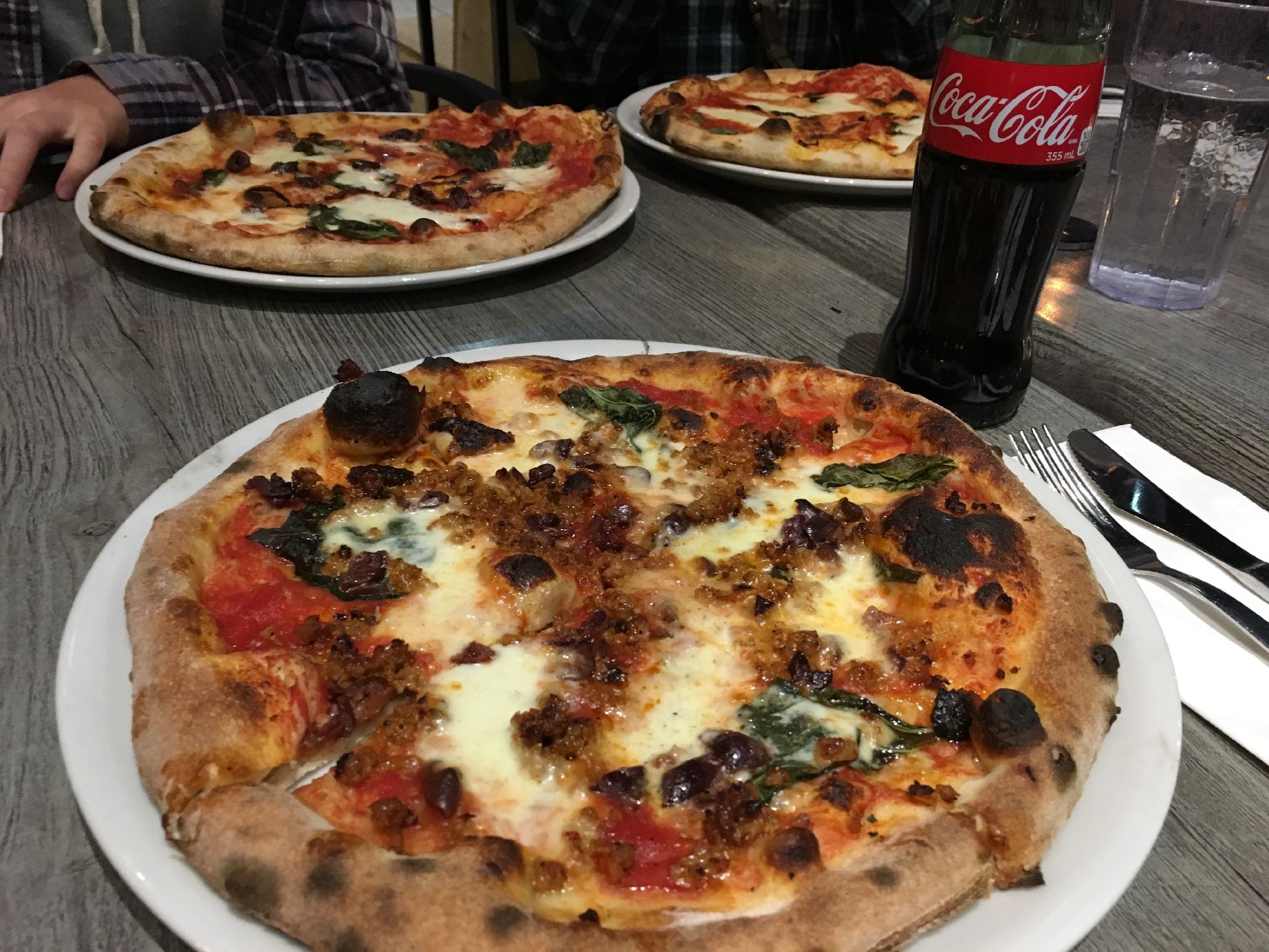 Three gourmet pizzas on a table