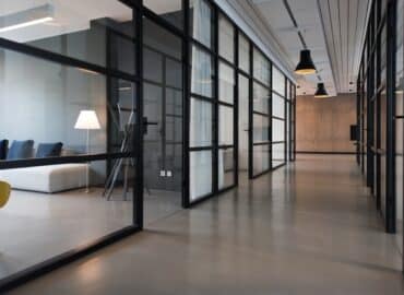 hallway between glass-panel doors inside commercial real estate building