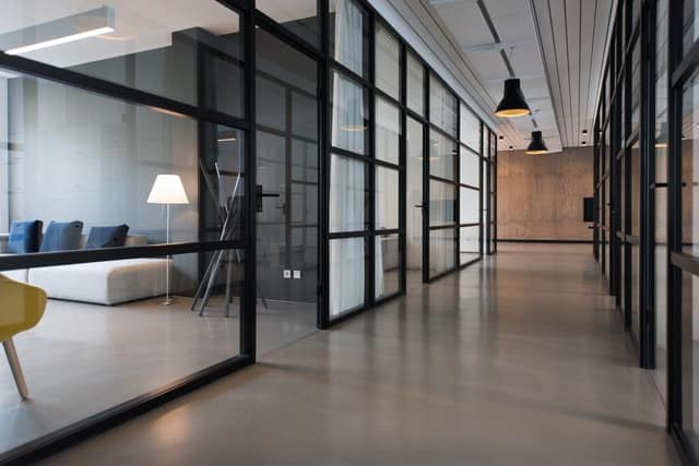 hallway between glass-panel doors inside commercial real estate building